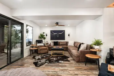 a living room with a couch and a table at Dogwood Retreat- Family friendly Epic Views in Shaver Lake