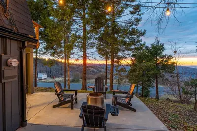 a patio with chairs and a table with a view at Dogwood Retreat- Family friendly Epic Views in Shaver Lake