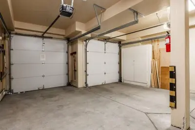 a garage with three white garage doors in it at Mammoth Gateway Village #3 in Mammoth Lakes
