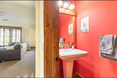 a bathroom with a sink and a red wall at Lodges 1123 in Mammoth Lakes