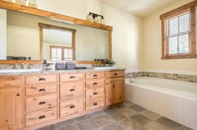a bathroom with two sinks and a tub and a large mirror at Lodges 1123 in Mammoth Lakes