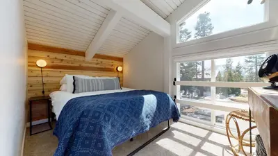 a bedroom with a bed and a large window at Seasons Four 152 in Mammoth Lakes