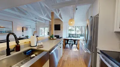 a kitchen with a sink and a refrigerator at Seasons Four 152 in Mammoth Lakes