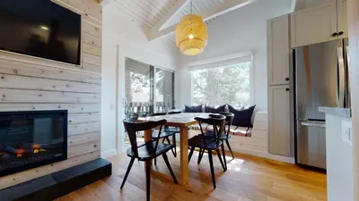 a dining room with a table and chairs and a fireplace at Seasons Four 152 in Mammoth Lakes