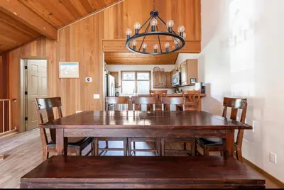 a dining room with a large wooden table and chairs at Winterset 4 in Mammoth Lakes