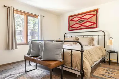 a bedroom with a bed and a chair at Winterset 4 in Mammoth Lakes
