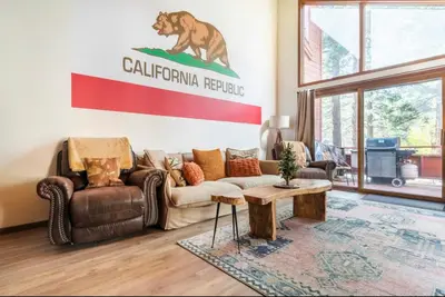 a living room with a bear sign on the wall at Winterset 4 in Mammoth Lakes