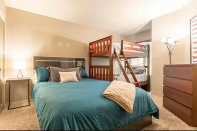 a bedroom with a bed and bunk beds in it at Snowcreek 569 in Mammoth Lakes