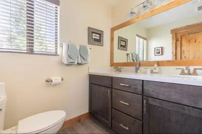 a bathroom with a sink and a toilet and a mirror at Mammoth Sierra Townhome 1 in Mammoth Lakes
