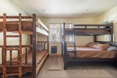 a room with two bunk beds and a bed at Mammoth Sierra Townhome 1 in Mammoth Lakes