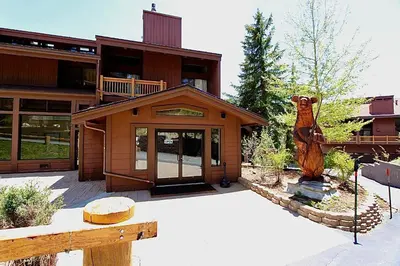 a house with a bear statue in front of it at Mammoth Ski and Racquet 116 in Mammoth Lakes