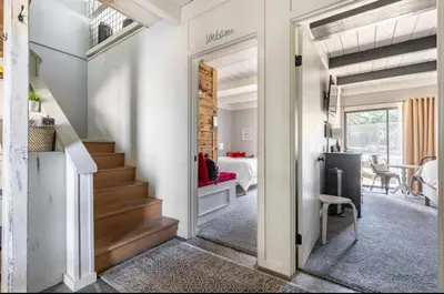 a hallway with a staircase leading to a living room at Villa De Los Pinos 15 in Mammoth Lakes