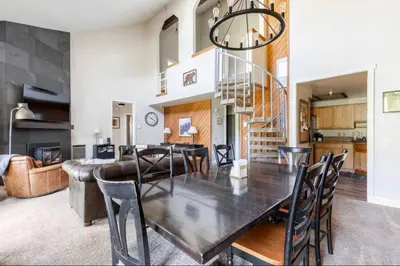 a dining room and living room with a table and chairs at Aspen Creek 230 in Mammoth Lakes