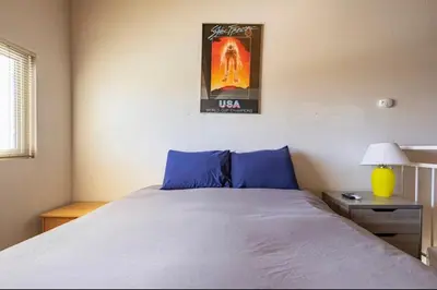 a bedroom with a bed and a picture on the wall at Mammoth View Villas 39 in Mammoth Lakes