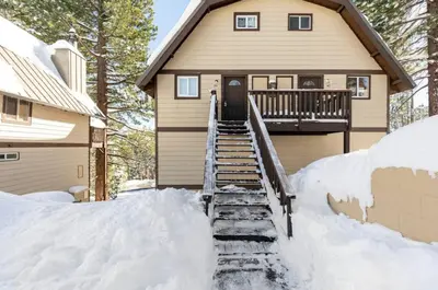 a house with snow on the stairs in front of it at Mammoth View Villas 39 in Mammoth Lakes