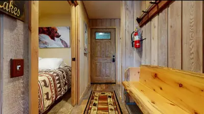 a bedroom with a bed and a wooden door at Viewpoint 151 in Mammoth Lakes