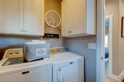 a laundry room with a washing machine and cabinets at Stunning View! UNR-Groups-Deck-Reno-Minerva House in Reno