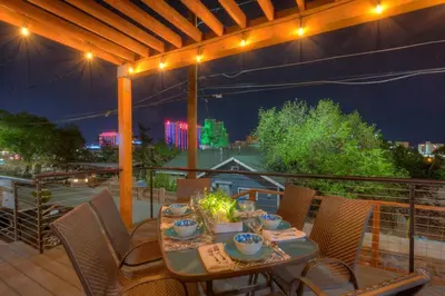 a table and chairs on a balcony at night at Stunning View! UNR-Groups-Deck-Reno-Minerva House in Reno