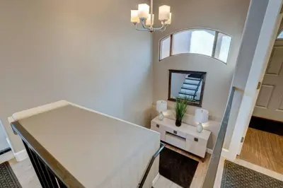 a white room with a table and a mirror at Stunning View! UNR-Groups-Deck-Reno-Minerva House in Reno