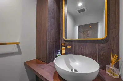 a bathroom with a white sink and a mirror at Zephyr Chalet Steps from Zephyr Cove in Glenbrook