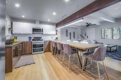 a kitchen with a large wooden table and chairs at Zephyr Chalet Steps from Zephyr Cove in Glenbrook
