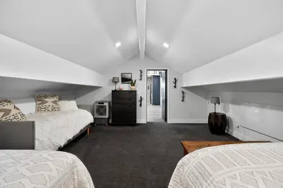 a white room with two beds and a hallway at Sierra Sanctuary with Hot Tub home in Truckee