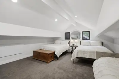 a white room with two beds and a mirror at Sierra Sanctuary with Hot Tub home in Truckee
