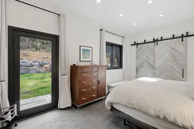 a bedroom with a bed and a dresser and a window at Sierra Sanctuary with Hot Tub home in Truckee