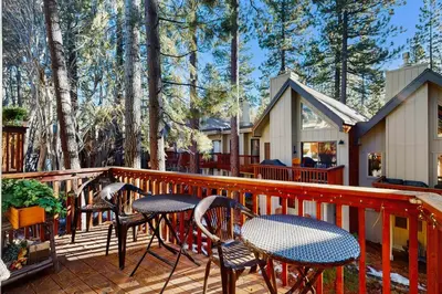 a deck with chairs and tables and a house at Double Suite Diamond Retreat in Incline Village