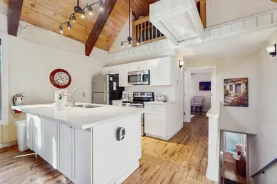 a kitchen with white cabinets and a clock on the wall at Double Suite Diamond Retreat in Incline Village