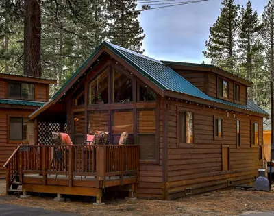a log cabin with a porch and a deck at Near Ski, Beaches, Pet Friendly, Full kitchen in South Lake Tahoe