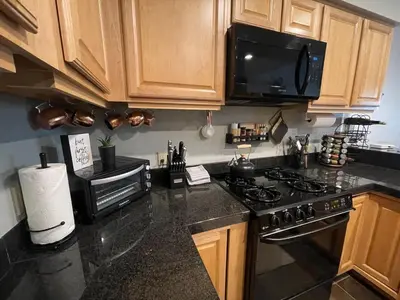 a kitchen with a stove and a microwave at Ski-in Ski-out Family Condo steps from lifts in Kirkwood