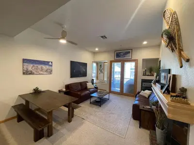 a living room with a couch and a table at Ski-in Ski-out Family Condo steps from lifts in Kirkwood