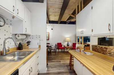 a kitchen with white cabinets and a dining room at Vintage Tahoe Chic at Incline Village in Incline Village