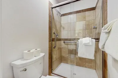 a bathroom with a toilet and a glass shower at Vintage Tahoe Chic at Incline Village in Incline Village
