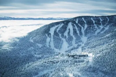an aerial view of a mountain with snow covered trees at Ritz-Carlton Northstar Luxury Ski-In Ski-Out in Truckee