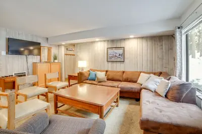 a living room with a couch and a table at 1 Mi to Village and Eagle Lodge Condo with Fireplace in Mammoth Lakes