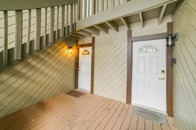 an empty room with a white door and a wooden floor at 1 Mi to Village and Eagle Lodge Condo with Fireplace in Mammoth Lakes