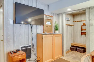 a living room with a tv on the wall at 1 Mi to Village and Eagle Lodge Condo with Fireplace in Mammoth Lakes