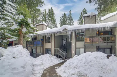 a house with snow piled up in front of it at 1 Mi to Village and Eagle Lodge Condo with Fireplace in Mammoth Lakes