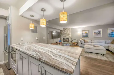 a large kitchen with a large marble counter in a living room at Bavarian Village Escape For 6 in South Lake Tahoe