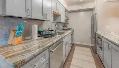 a kitchen with white cabinets and a counter top at Bavarian Village Escape For 6 in South Lake Tahoe