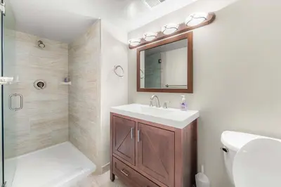 a bathroom with a sink and a toilet and a mirror at Bavarian Village Escape For 6 in South Lake Tahoe