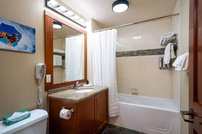 a bathroom with a sink and a tub and a toilet at Top Floor Village Ski-In/Ski-Out Condo in Olympic Valley