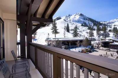 a balcony with a view of a snow covered mountain at 3BR Condo in Village at Palisades - Premier in Olympic Valley