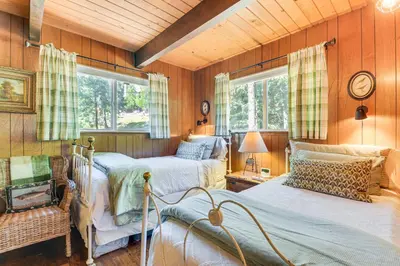 a bedroom with two beds and two windows at The Green Hideaway Arnold Cabin in the Pines! in Arnold