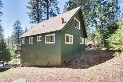 a green tiny house on top of a hill at The Green Hideaway Arnold Cabin in the Pines! in Arnold