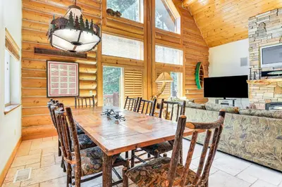 a dining room with a wooden table and chairs at Peaceful Escape in the Pines Arnold Cabin with Deck in Arnold