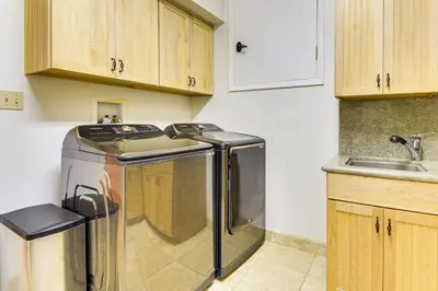 a kitchen with a washing machine and a sink at Peaceful Escape in the Pines Arnold Cabin with Deck in Arnold