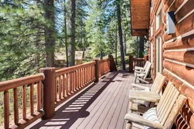 a wooden deck with benches on the side of a cabin at Peaceful Escape in the Pines Arnold Cabin with Deck in Arnold
